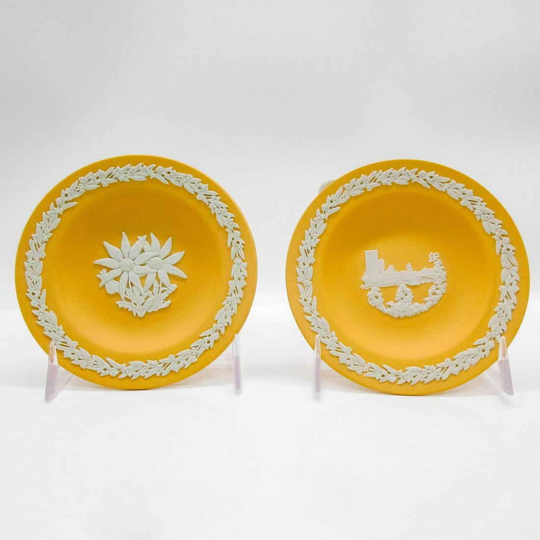 Set of 2 Wedgwood Cane Yellow Jasperware Plates: Two cane yellow stoneware plates with cream vine sprigs and leaf and berry rim in relief. Impressed Wedgwood backstamp. #wedgwood #jasperware #australia #flowers Issued: 20th c. Dimensions: 4.5" dia. 