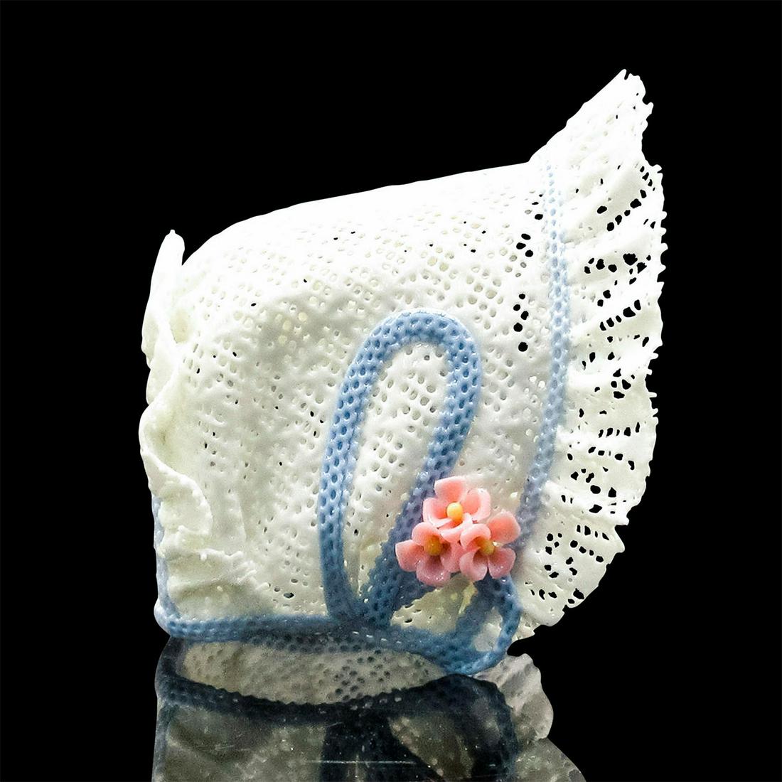 Closed Hat w/Blue Ribbon 1001570 - Lladro Porcelain Decor: Elegant miniature lace bonnet style hat with blue bow. On acrylic stand. Lladro backstamp underneath. Artist: Design & Decoration Dept. Issued: 1987-1991 Dimensions: 2.25"H Manufacturer: Lladro Countr