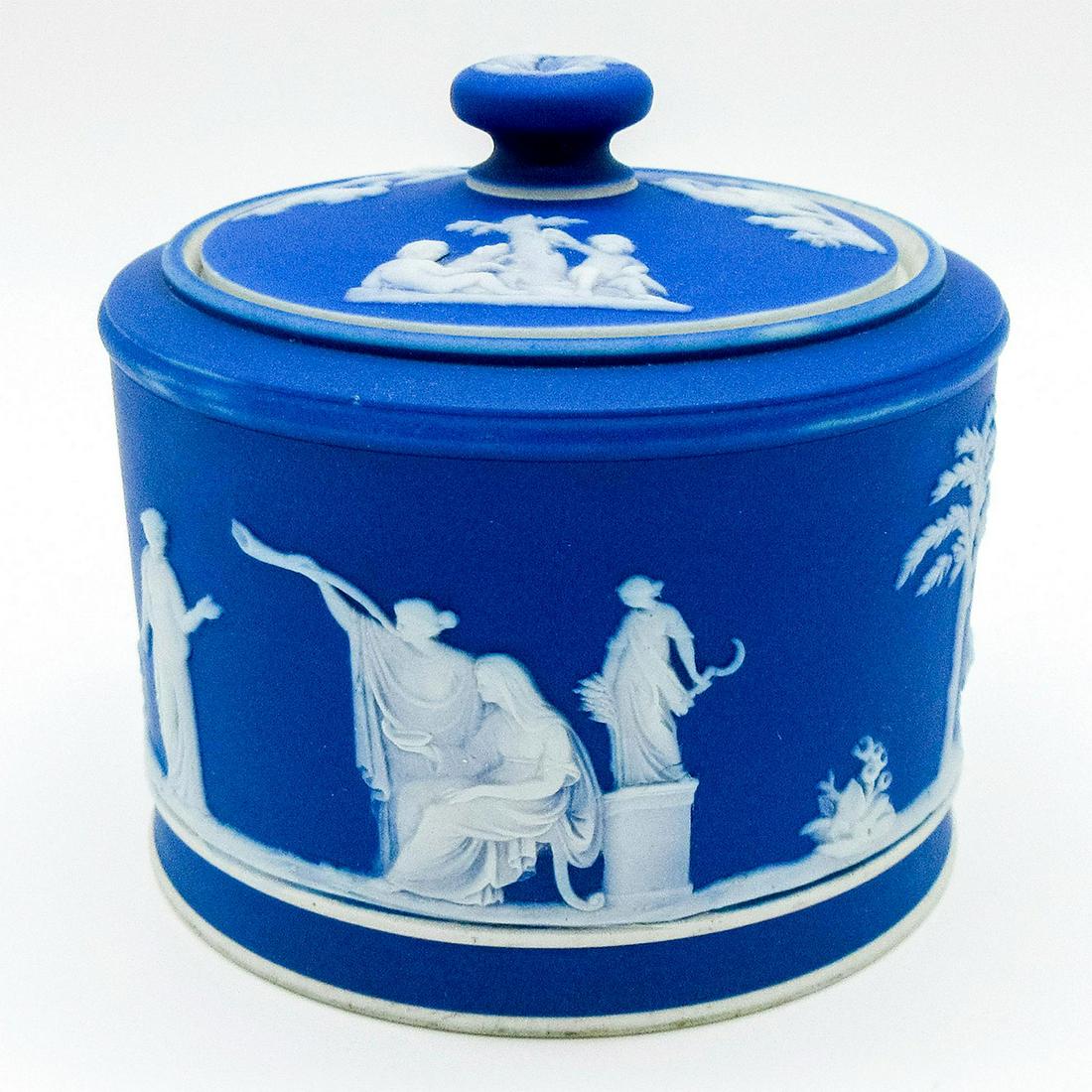 Wedgwood Blue Jasperware, Sugar Box and Lid: Blue dipped Jasperware lidded sugar box with Neoclassical figures in white relief. Impressed Wedgwood backstamp. #wedgwood #jasperware Issued: 20th c. Dimensions: 3.25"H x 3.5" dia. Manufacturer: Wedg