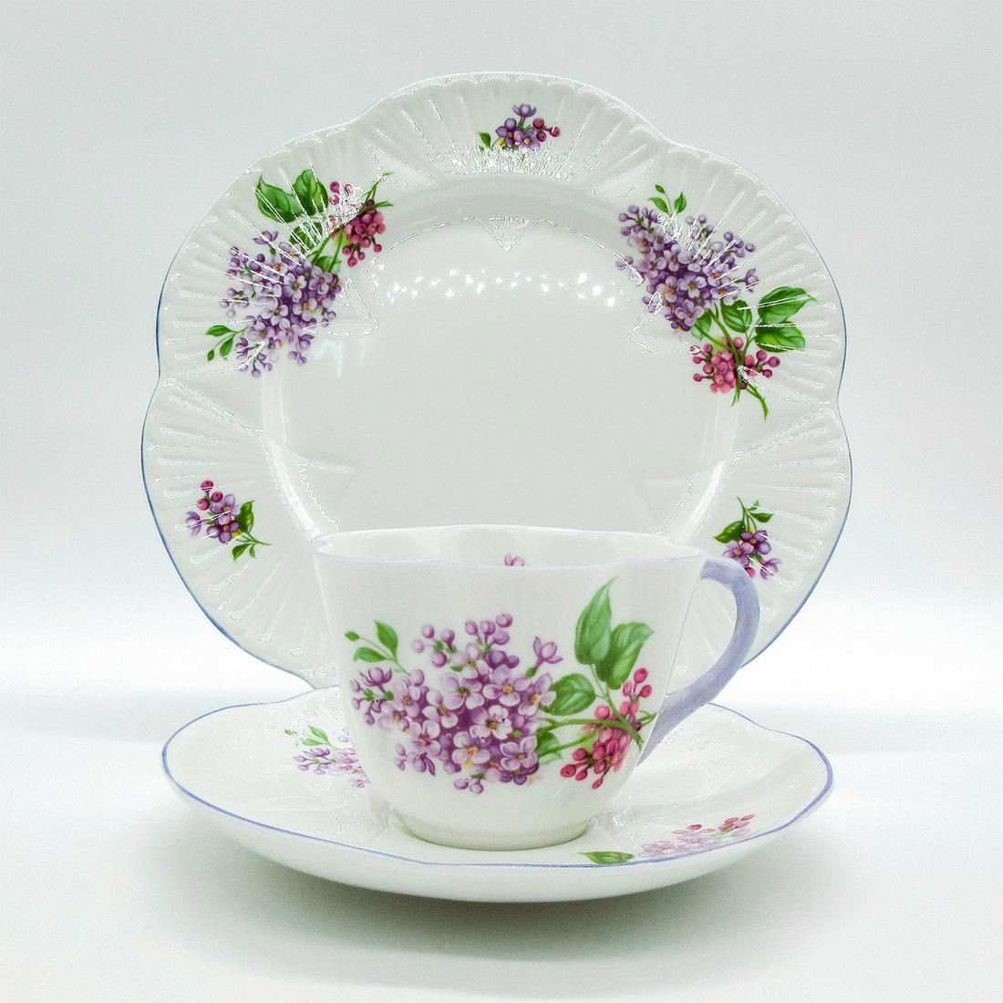 3pc Shelley England Dainty Tea Set Trio, Lilac Time: Bone china tea set; Dainty shape. Purple lilac flower pattern with lavender trim. Shelley England backstamp. 14293 stamped on base. Cup size - 2.5"H x 3.5" diameter (widest). Saucer size - 0.7