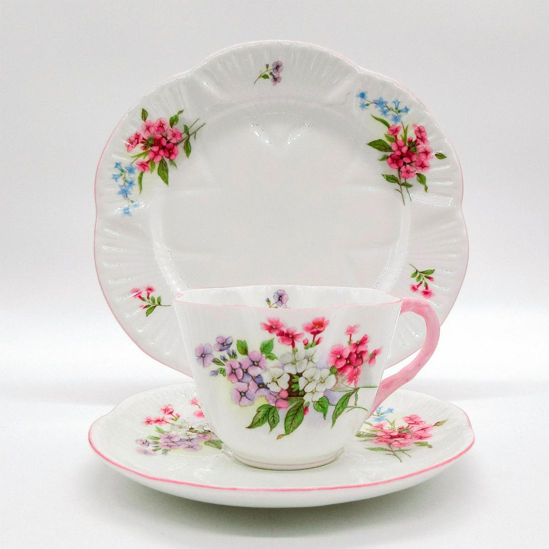 3pc Shelley England Dainty Tea Set Trio, Stocks: Vintage bone china tea wares; Dainty style. Pink and blue floral motif with pastel pink rim. Shelley England backstamp. 13428 hand-written on base. Cup size - 2.5"H x 3.5" diameter (widest). S