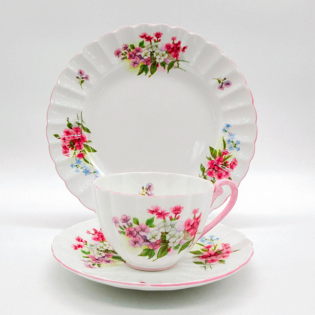 3pc Shelley England Ludlow Tea Set Trio, Stocks: Vintage bone china tea wares; Ludlow shape. Pink and purple floral motif with pastel pink scalloped rim. Shelley England backstamp. 13428 hand-written on base. Cup size - 2.25"H x 3.25" diamet