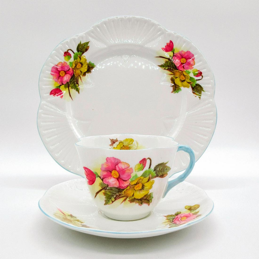 3pc Shelley England Tea Set Trio, Begonia: Vintage bone china tea wares; Dainty shape. Yellow and pink begonia flower pattern with pastel blue rim. Shelley England backstamp. Scalloped rim. Cup size - 2.5"H x 3.5" diameter (widest). Sa