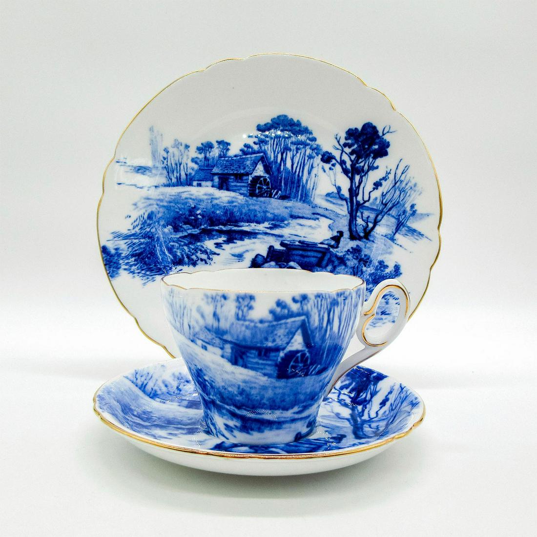3pc Shelley England Tea Set Trio, Blue Devon: Bone china tea set; Old mill scene in blue and white coloration. Gold gilt accents. Shelley England backstamp. 12734-10 hand-written on base. Cup size - 2.5"H x 3.5" diameter (widest). Saucer