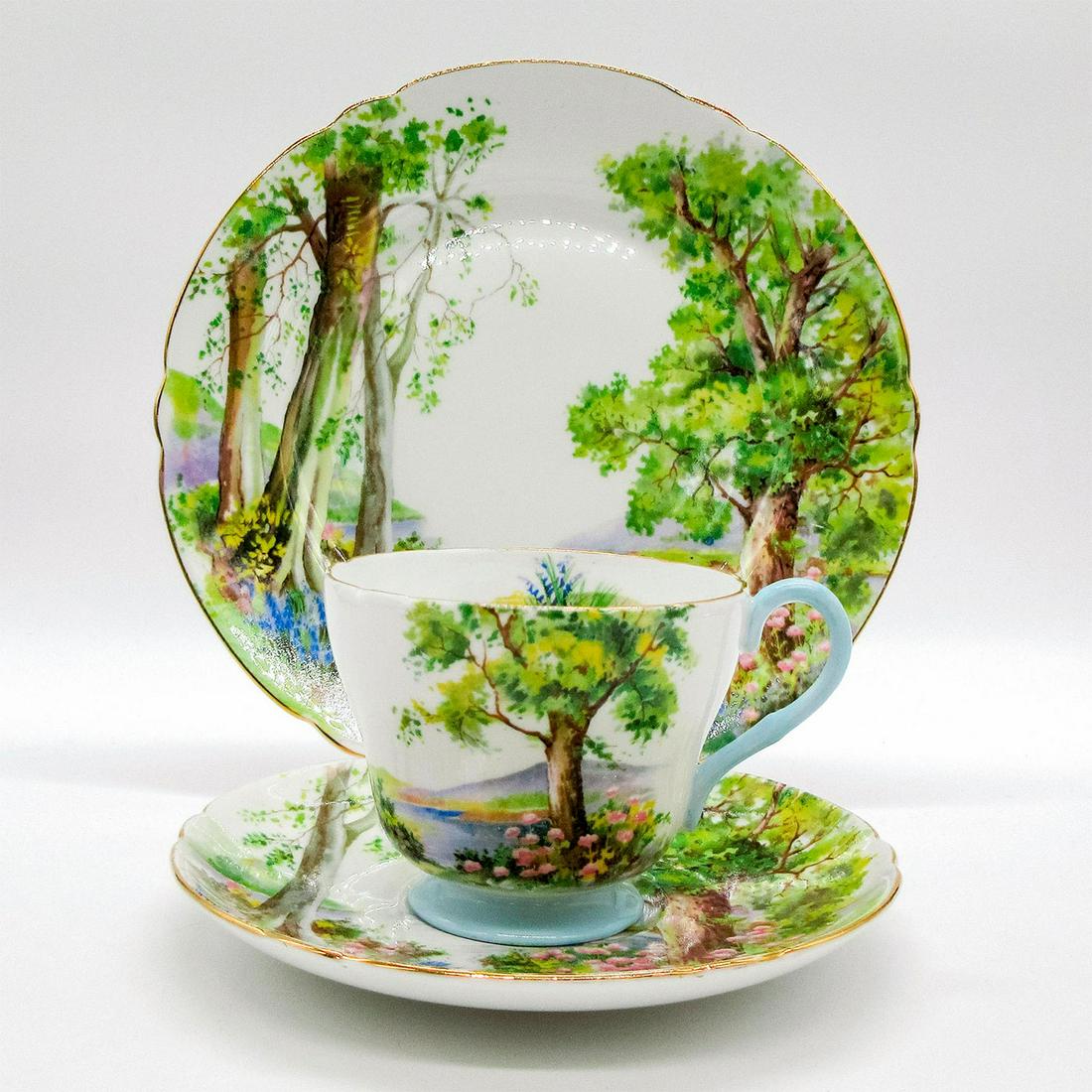 3pc Shelley England Tea Set Trio, Woodland: Vintage bone china tea wares; Richmond shape. English woodland scene with gold rim. Shelley England backstamp. 13348 stamped on base. Cup size - 2.75"H x 3.25" diameter (widest). Saucer size -