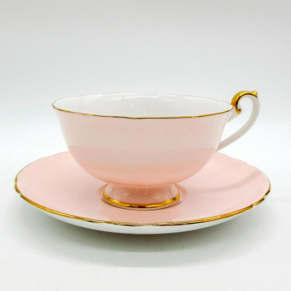 2pc Shelley England Cup and Saucer, Apple and Grape: Vintage bone china tea wares; Lincoln shape. Pastel pink body with apple and grape pattern interior. Shelley England backstamp. Gold gilt accents. 14208/59 hand-written on base. Cup size - 2.25"H