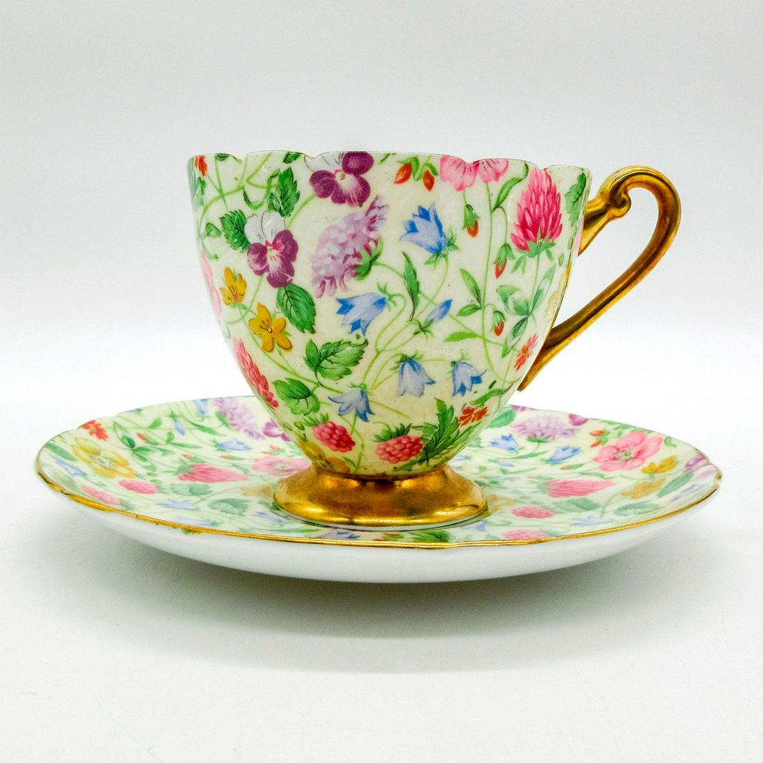 2pc Shelley England Cup and Saucer, Country Side: Vintage bone china tea wares; Ripon shape. Floral chintz pattern with gold gilt accents. Scalloped rim. Shelley England backstamp. 13701 hand-written on base. Cup size - 3"H x 3.25" diameter (