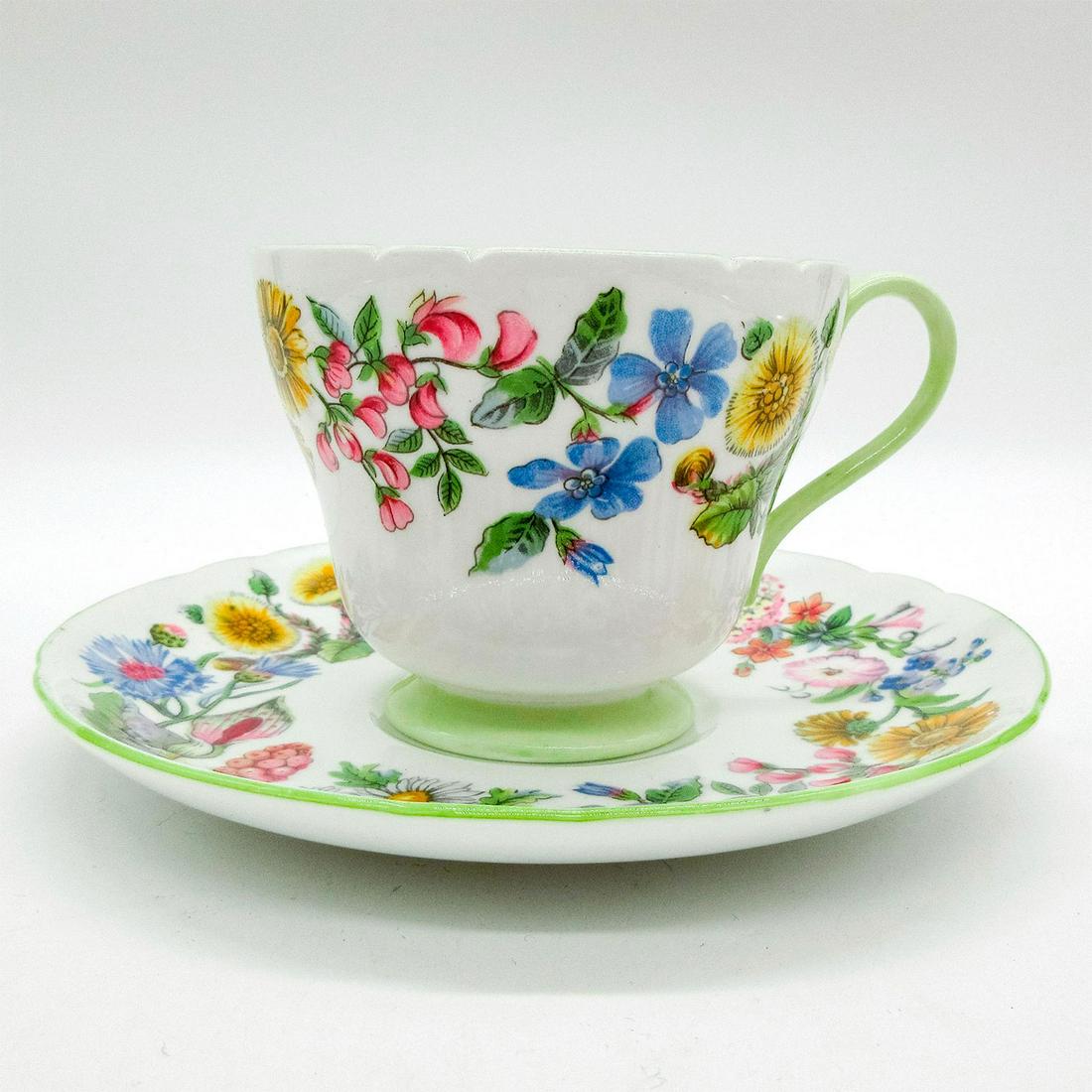 2pc Shelley England Cup and Saucer, Hedgerow: Vintage bone china tea wares; Windsor shape. Colorful floral motif with pistachio green rim. Shelley England backstamp. 13492 stamped on base. Cup size - 2.75"H x 3.25" diameter (widest). Sauc
