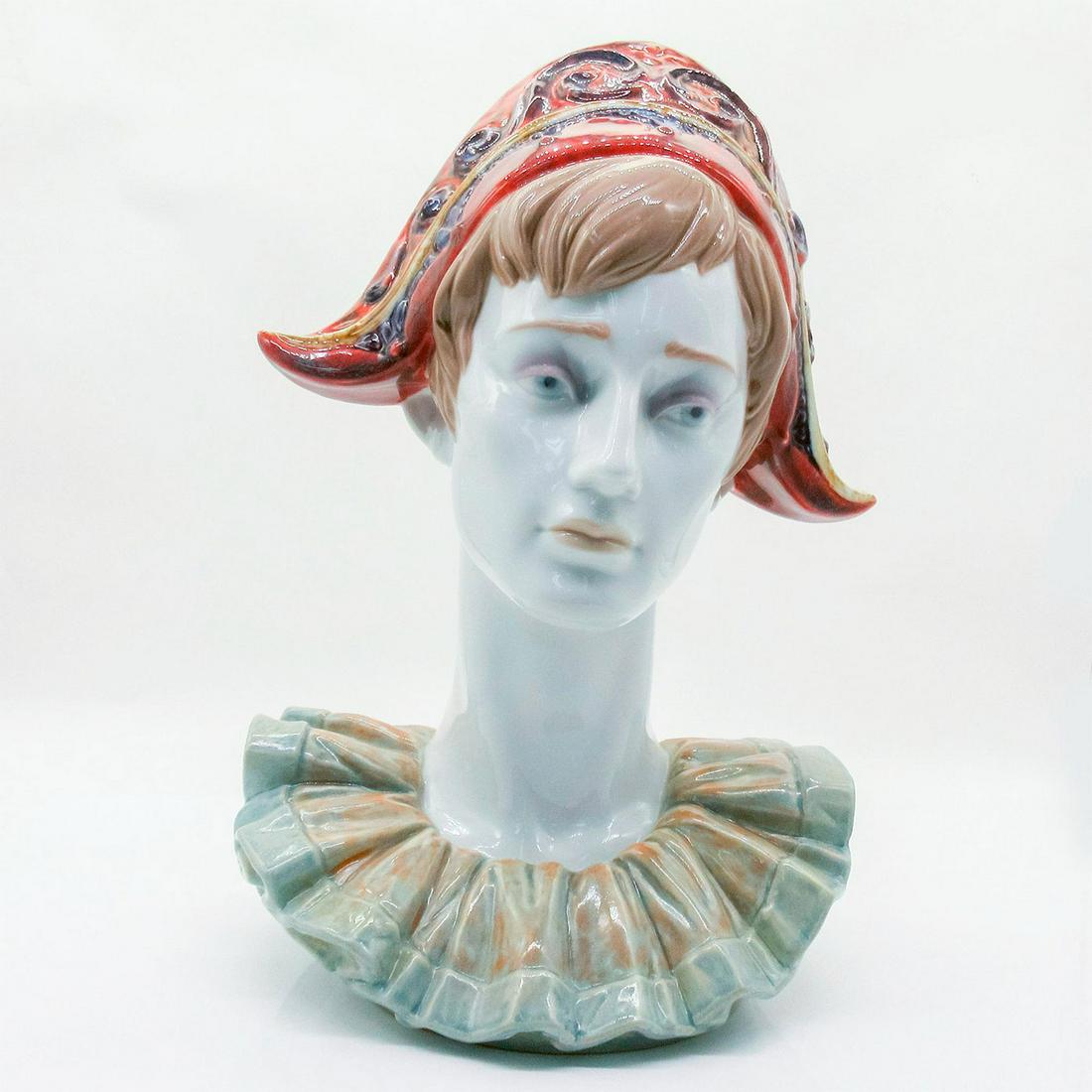 Pensive Harlequin 1006434 - Lladro Porcelain Figurine: Glossy finish; Lladro backstamp on bottom. Artist: Virginia Gonzalez Issued: 1997-1998 Dimensions: 14"H Manufacturer: Lladro Country of Origin: Spain