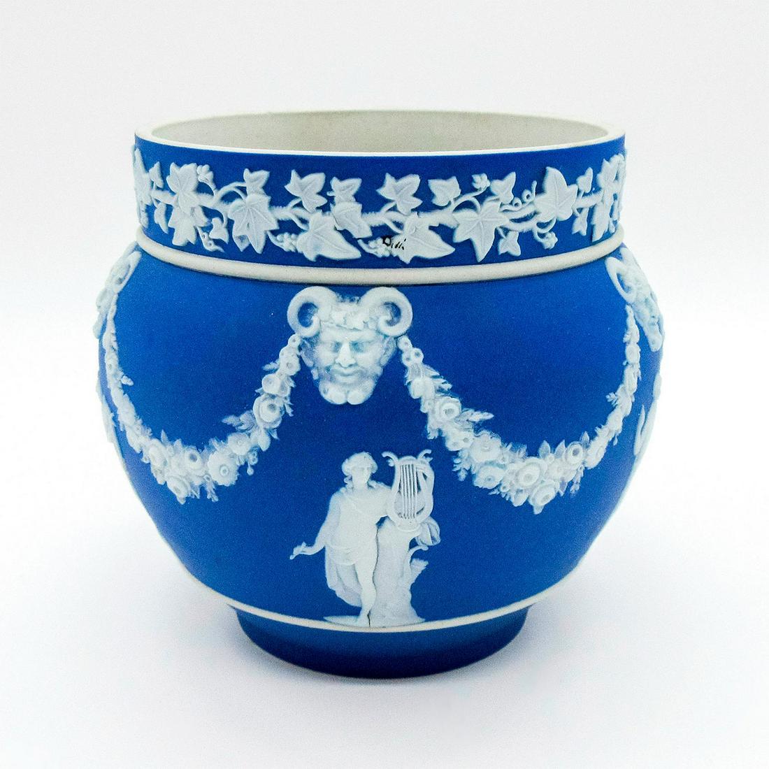 Wedgwood Blue Jasperware Jardeniere: Small jardeniere dipped in blue Jasperware with Neoclassical figures in white relief. Impressed Wedgwood backstamp. Use-related wear. #wedgwood #jasperware Issued: Early 20th c. Dimensions: 4.25"H Man
