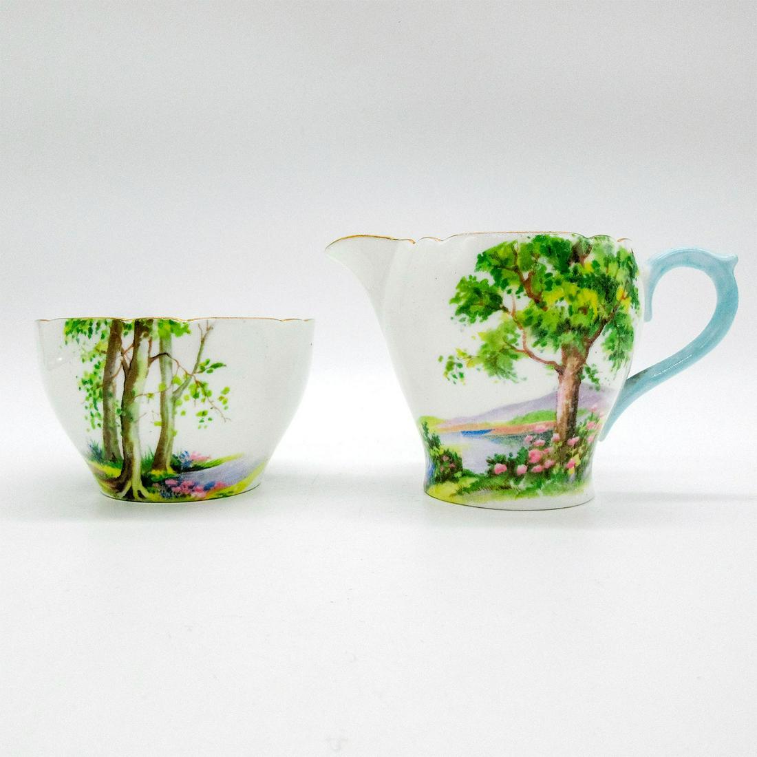 2pc Shelley England Open Sugar and Creamer, Woodland: Vintage bone china mini sugar and creamer set. Serene woodland design with gold gilt accents. Shelley England backstamp. 13348 stamped on base. Open sugar size - 2"H x 3" diameter. Cramer size