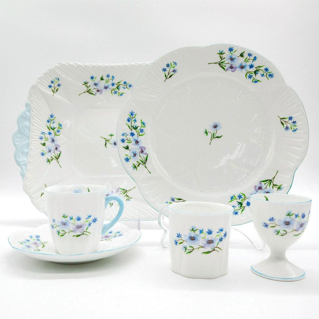 6pc Shelley England Assorted Bone China, Blue Rock: Dainty shape; blue rock flower pattern with pastel blue rim. Shelley England backstamp. 13591 stamped on base. This listing includes following items; demitasse cup and saucer - 2.5"H, single egg cup-