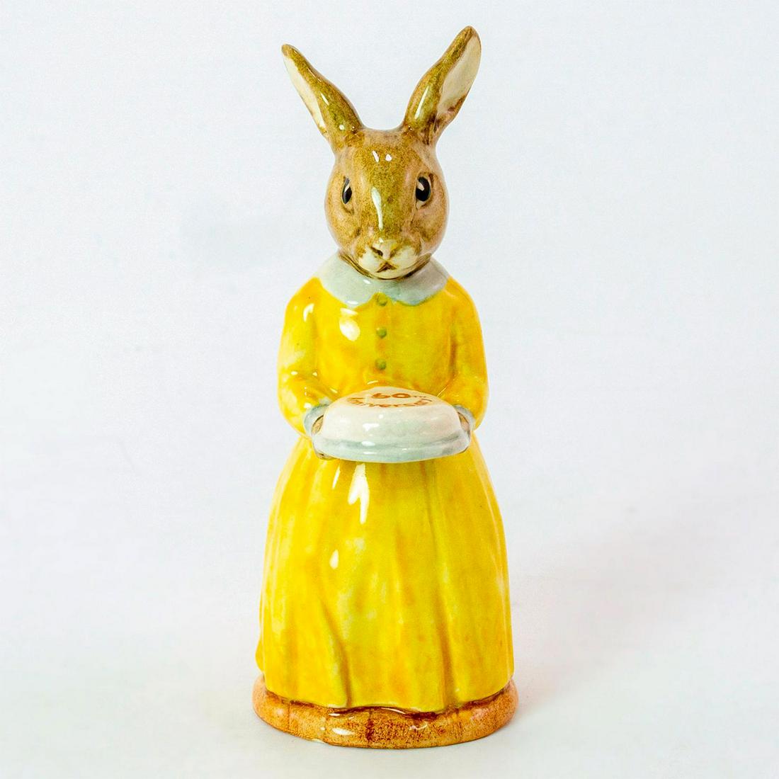 60th Anniversary DB137 - Royal Doulton Bunnykins: Lemon- yellow dress, white collar and cake. Royal Doulton backstamp. Weight: 2.4 oz Artist: G. Tongue Issued: 1994 - 1994 Dimensions: 4.5"H Country of Origin: England Manufacturer: Royal Doulton