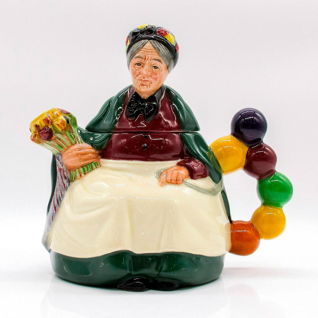 Old Balloon Seller - Teapot - Royal Doulton: Green, white, yellow, and maroon coloration. Royal Doulton backstamp. Artist: William K. Harper Issued: 1989 - 1991 Dimensions: 6.5"H Manufacturer: Royal Doulton Country of Origin: England