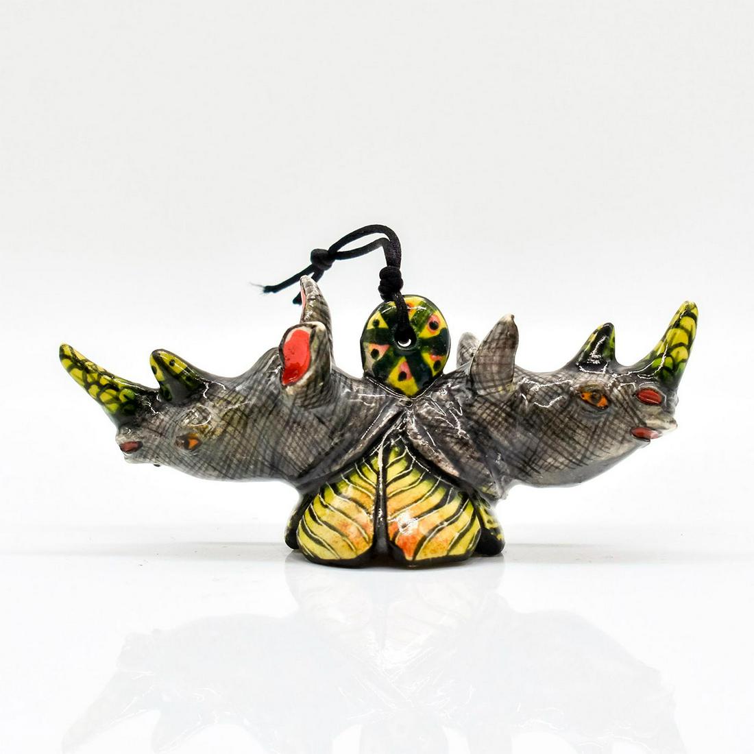Ardmore Studio Rhino Figural Ornament: Hand sculpted and hand painted ornament of opposite facing rhino busts, on a leaf base. Gold-colored charm marked 2019 hangs from the black string. Base marked by artists. #ardmore #ardmorestudios #rh