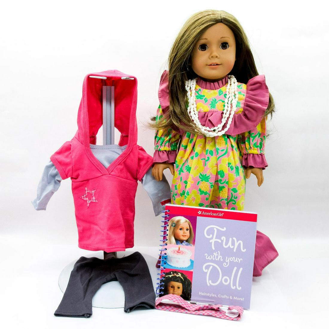 American Girl Just Like You 29 Doll: Doll with golden brown hair, medium complexion and curly hair in long colorful dress with shell necklace. In original box 20.5"L x 5"H x 8"W. Wearing pink Mary Jane shoes and includes additional casua