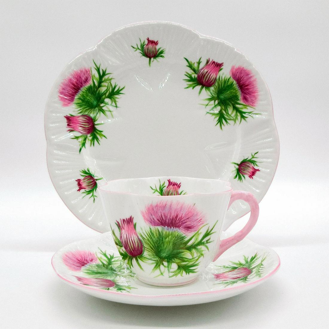 3pc Shelley England Dainty Tea Set Trio, Thistle: Vintage bone china tea wares; Dainty shape. Purple thistle flower pattern with pastel pink scalloped rim. Shelley England backstamp. 13820 stamped on base. Cup size - 2.5"H x 3.5" diameter (widest). S
