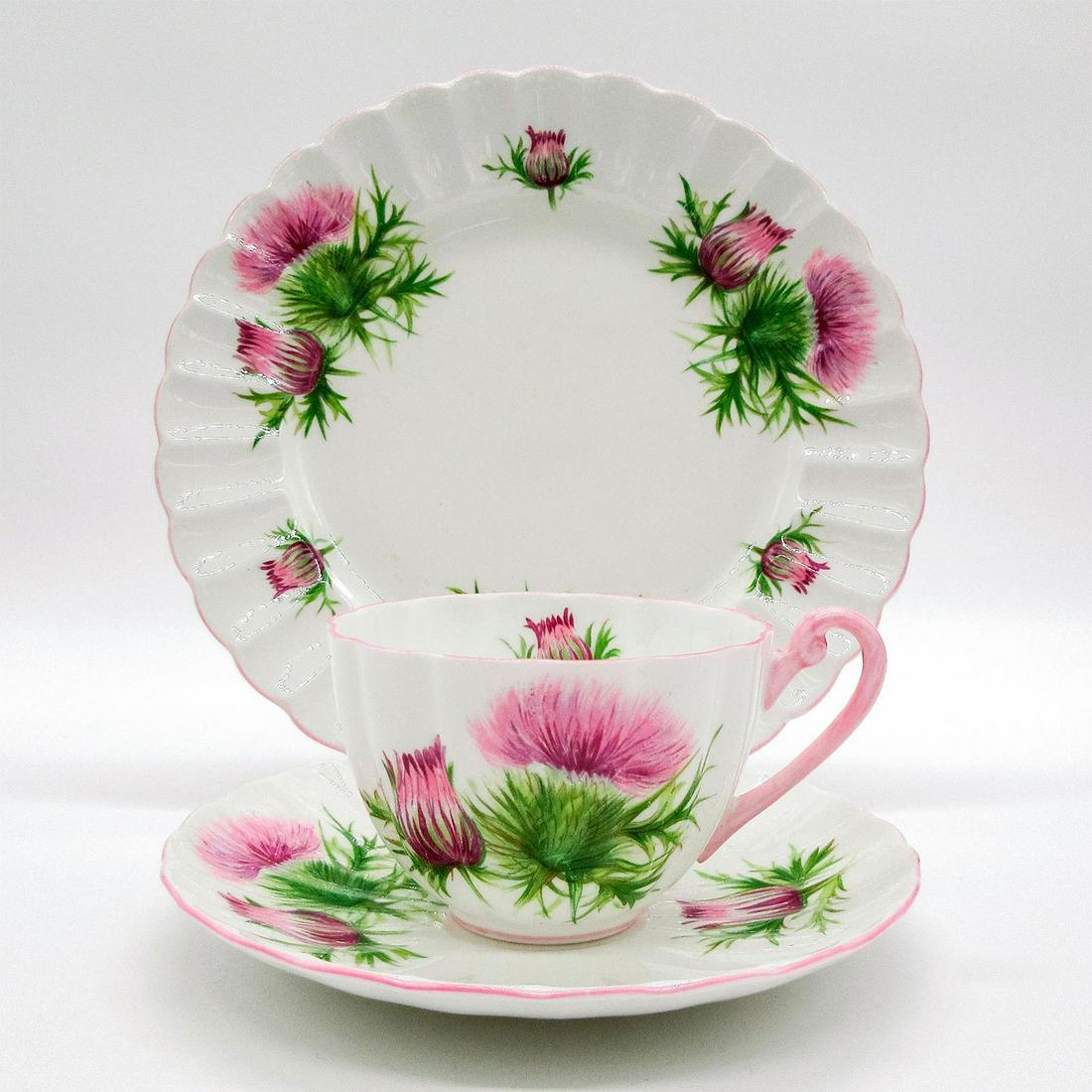 3pc Shelley England Ludlow Tea Set Trio, Thistle: Vintage bone china tea wares; Ludlow shape. Purple thistle flower pattern with pink scalloped rim. Shelley England backstamp. 13820 stamped on base. Cup size - 2.25"H x 3.25" diameter (widest). Saucer