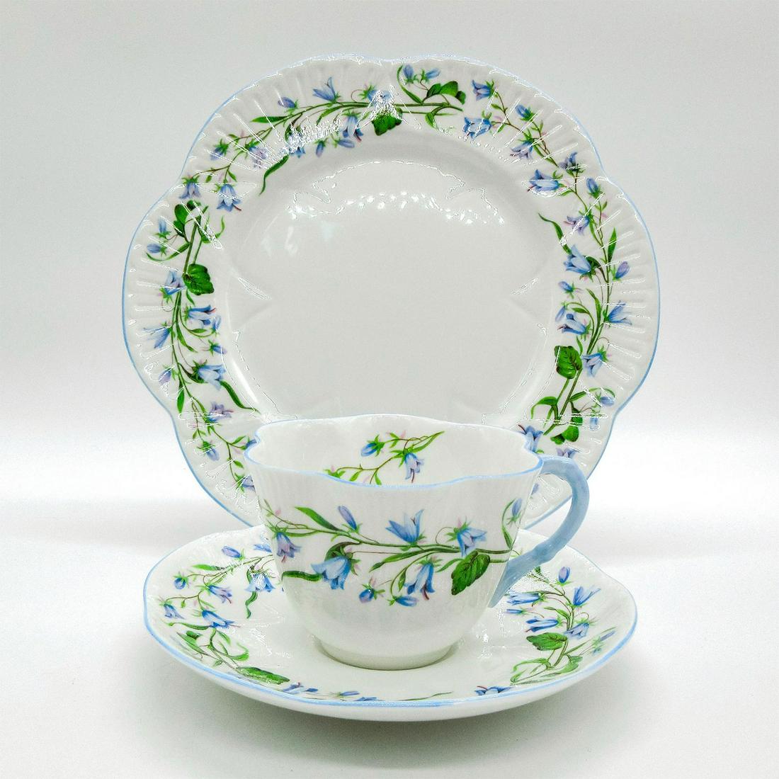 3pc Shelley England Tea Set Trio, Harebell: Vintage bone china tea set; Dainty shape. Pale blue harebell flower pattern with gold gilt accents. Shelley England backstamp. 13590 stamped on base. Cup size - 2.5"H x 3.5" diameter (widest). Saucer