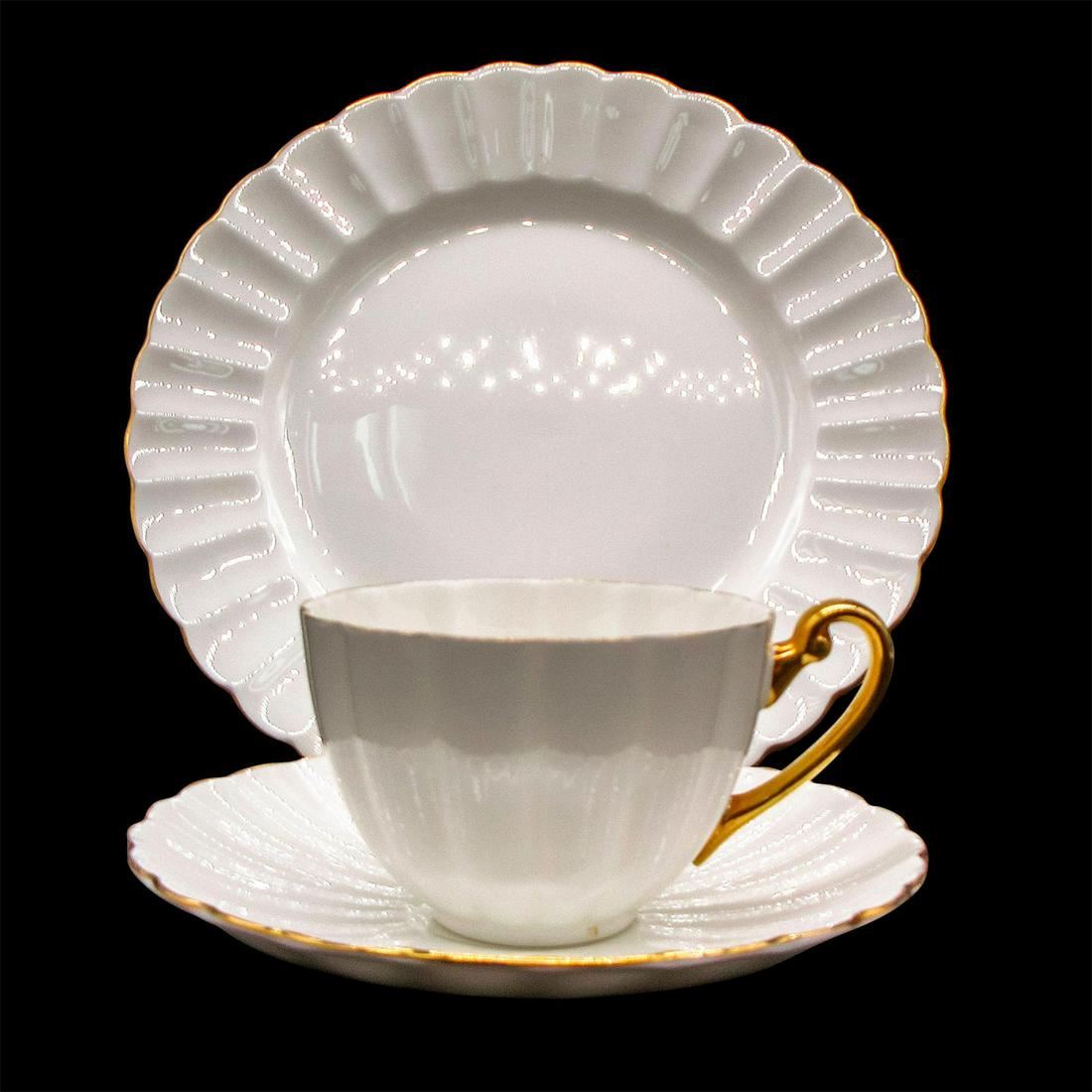 3pc Shelley England Ludlow Tea Set Trio, Regency: Vintage bone china tea wares; Ludlow shape. White body with gold gilt accents. Scalloped rim. Shelley England backstamp. Cup size - 2.25"H x 3.5" diameter (widest). Saucer size - 0.75"H x 5.5" diamete