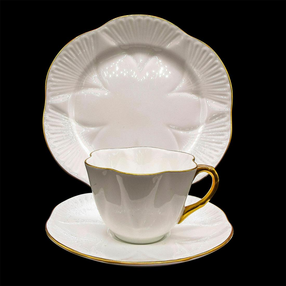 3pc Shelley England Dainty Tea Set Trio, Regency: Vintage bone china tea wares; Dainty shape. White body with gold gilt accents. Scalloped rim. Shelley England backstamp. Cup size - 2.5"H x 3.5" diameter (widest). Saucer size - 0.75"H x 5.75" diamete