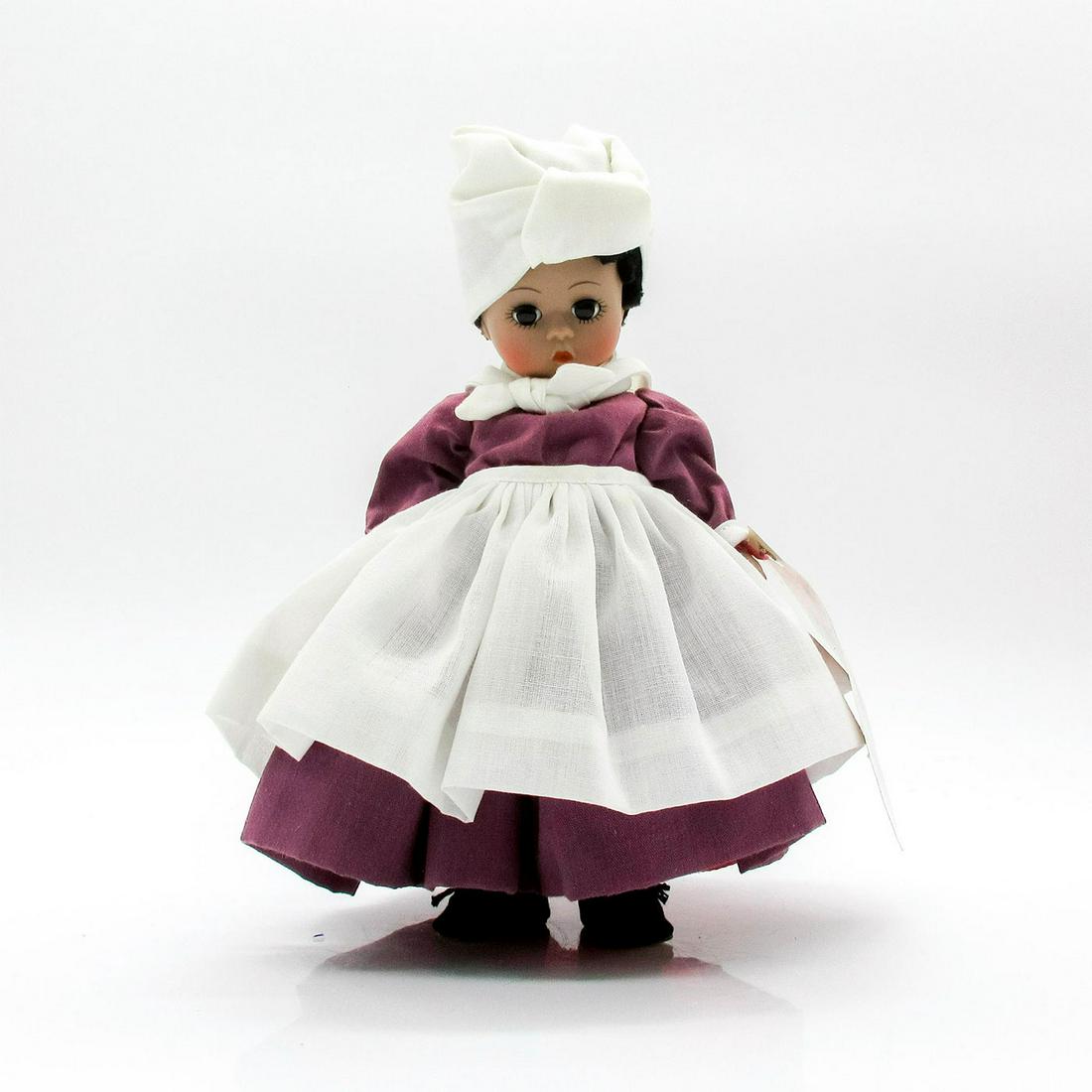 Madame Alexander Doll, Mammy: From the Scarlett Jubilee II collection. Based on the character Mammy from film "Gone with the Wind." Featured wearing an purple dress with white apron, headscarf, and neckerchief. Comes with red slip
