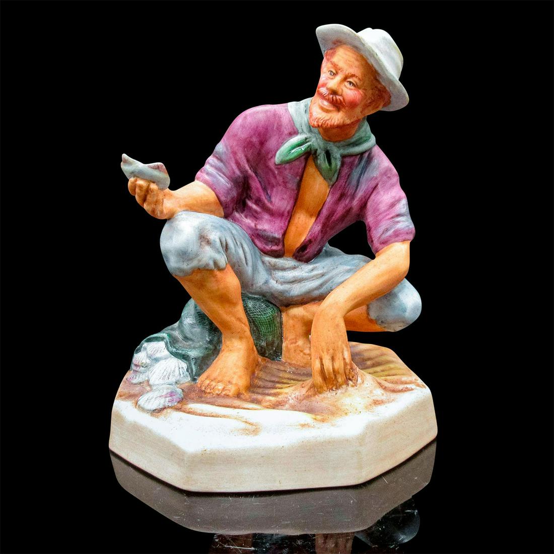 Beachcomber HN2487 - Royal Doulton Figurine: Matte finish, hand painted figurine. The man is in blue pants, purple shirt, and green kerchief neck. He is digging on the beach for shells.