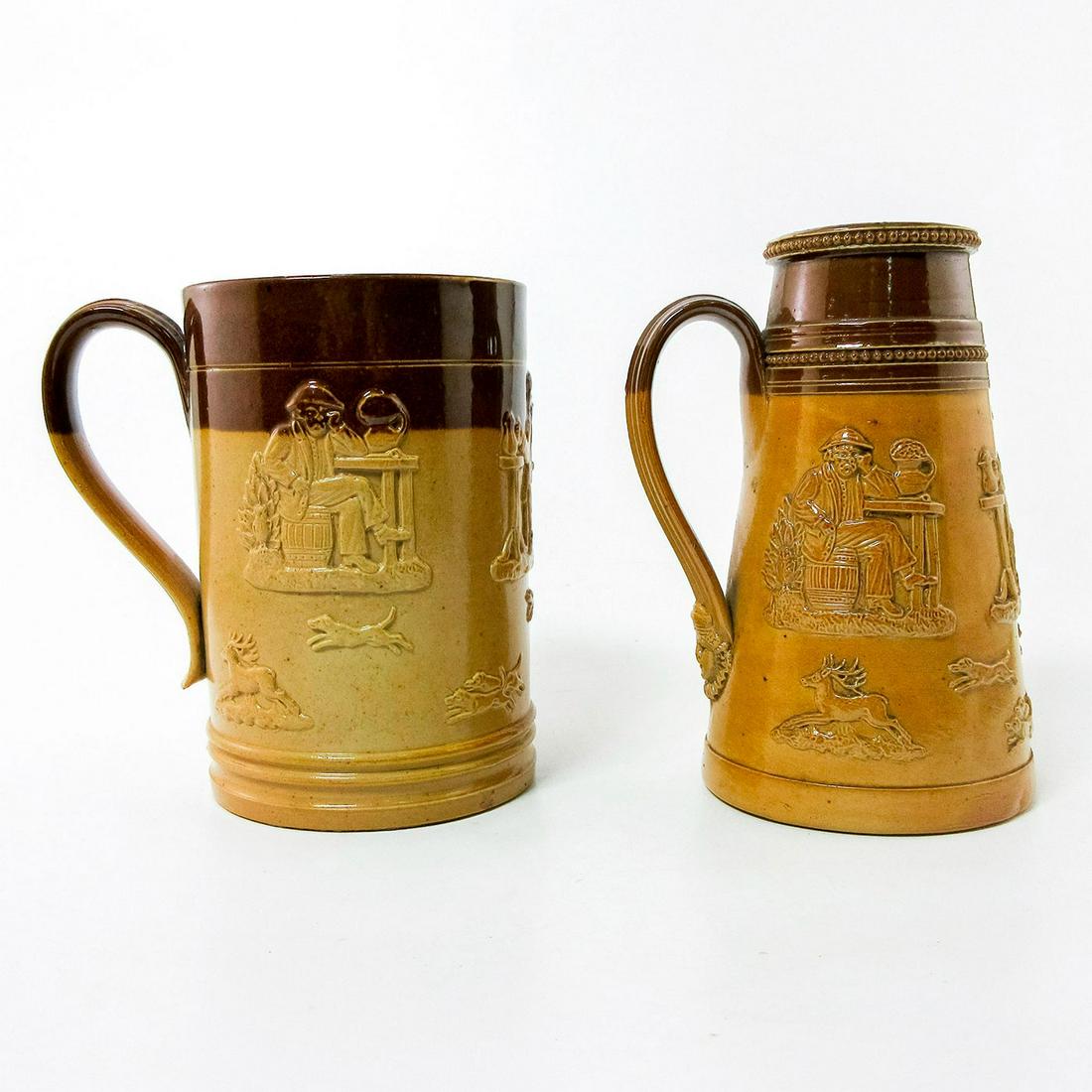 2 Antique Doulton Lambeth Stoneware Steins Gentlemen at Rest: Brown and tan steins of a men at rest and smoking a pipe. A stag and chasing dogs in bas-relief.