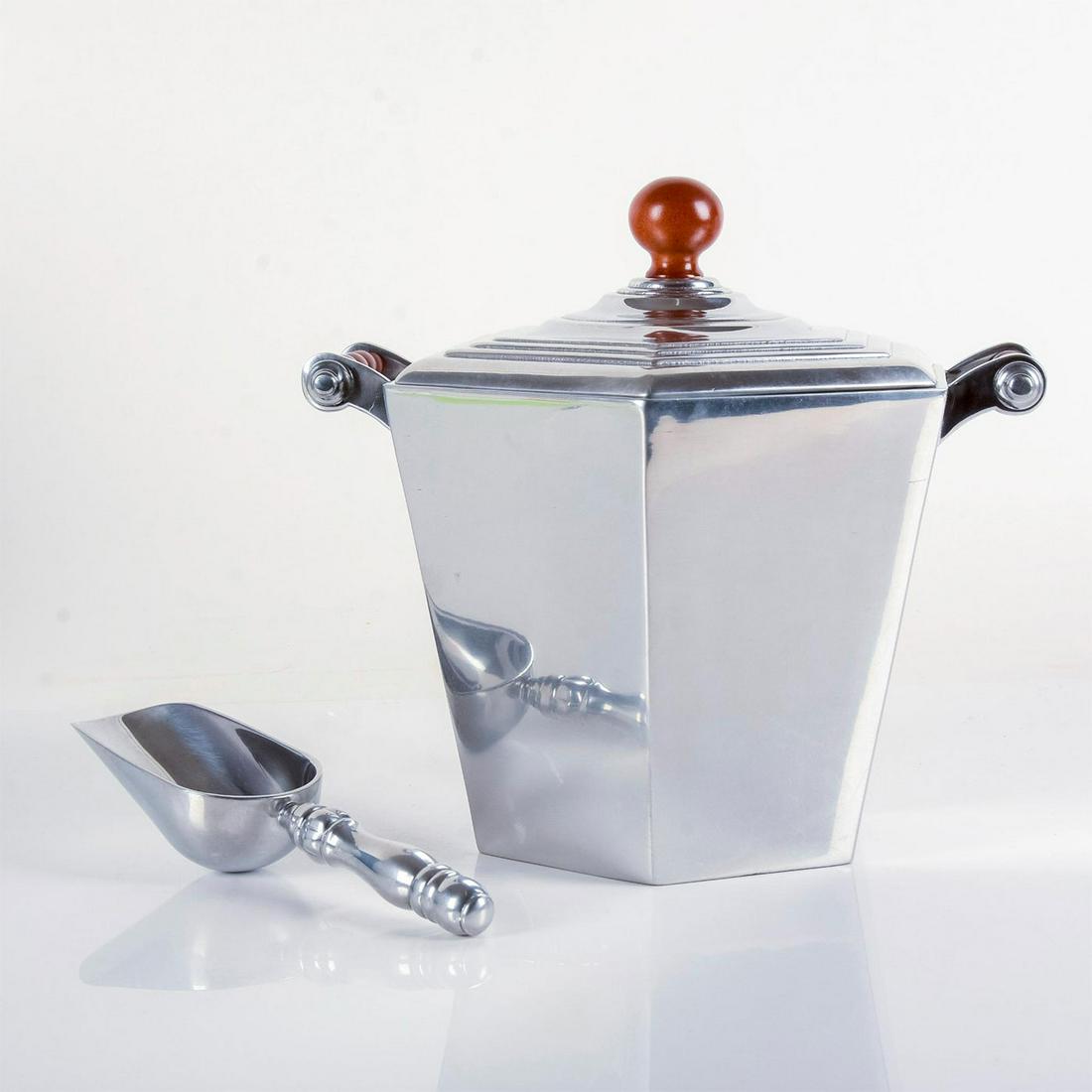 Reed and Barton Serveware, Ice Bucket and Scoop: Beautifully polished aluminum hexagonal bucket and ice scoop. Elegantly carved wooden handles with swirled texture.