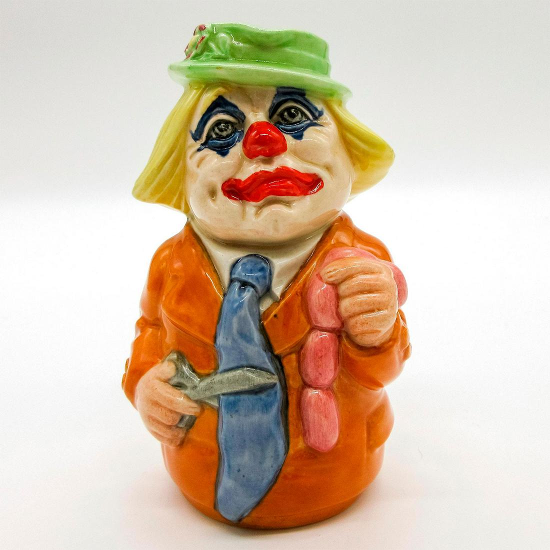 Charlie Cheer the Clown D6768 - Royal Doulton Toby Jug: Orange jacket; blue tie; green cap; yellow hair; pink sausages.