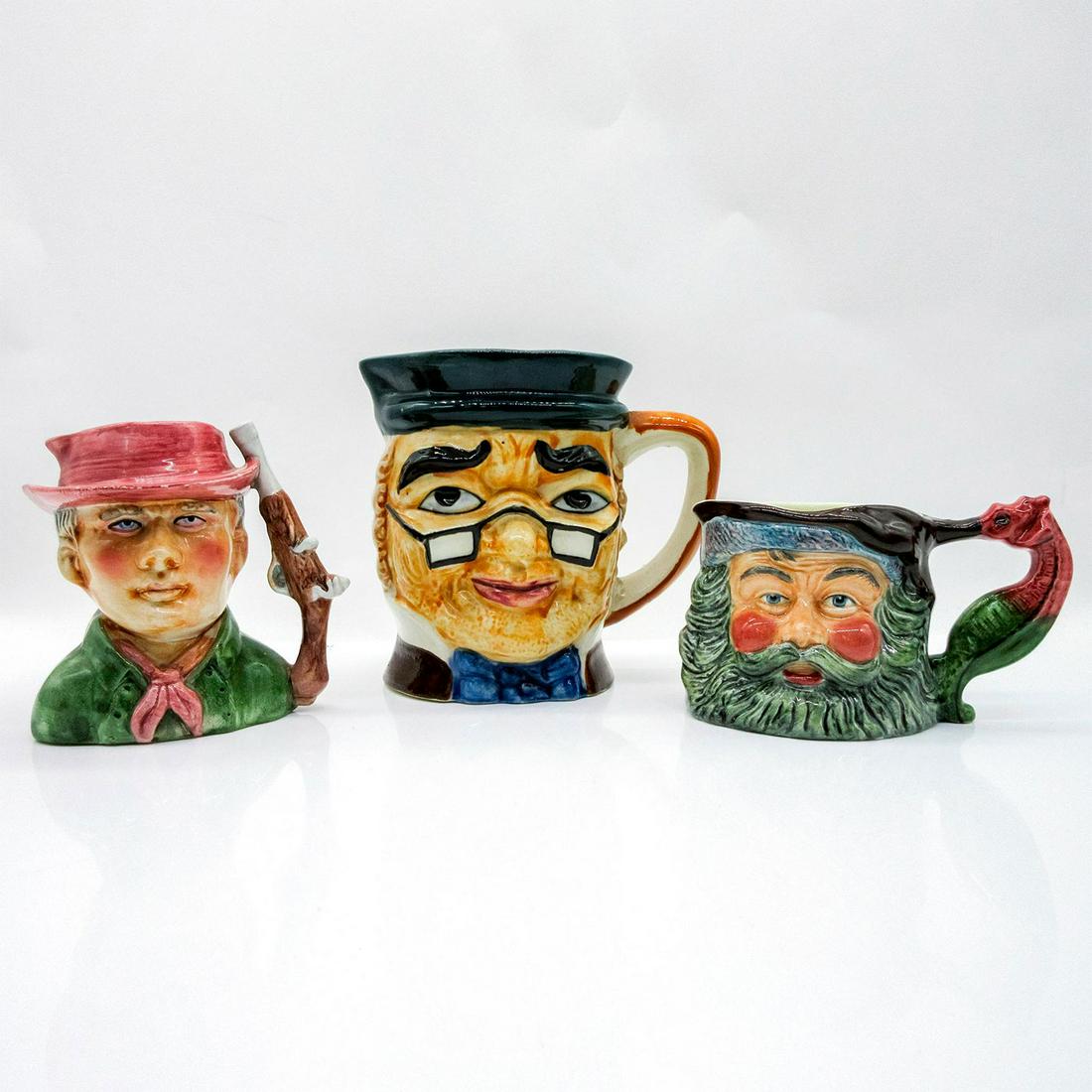 3pc Character Jugs, King Neptune, Gunslinger, Mr. Spectacles: Three porcelain jugs of characters in vibrant colors. King Neptune jug has Sylvac Staffordshire backstamp.