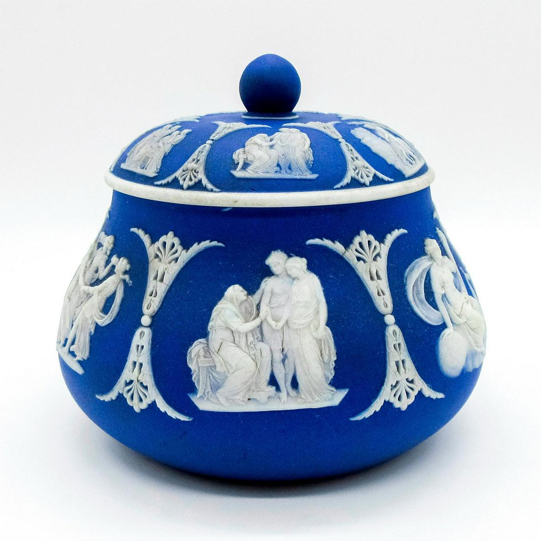 Wedgwood Blue Jasperware, Sugar Bowl: Lidded sugar bowl dipped in blue Jasperware, with Neoclassical figures in white relief. Impressed Wedgwood backstamp. Age-related wear. #wedgwood #jasperware Issued: Early 20th c. Dimensions: 4"H x 5"
