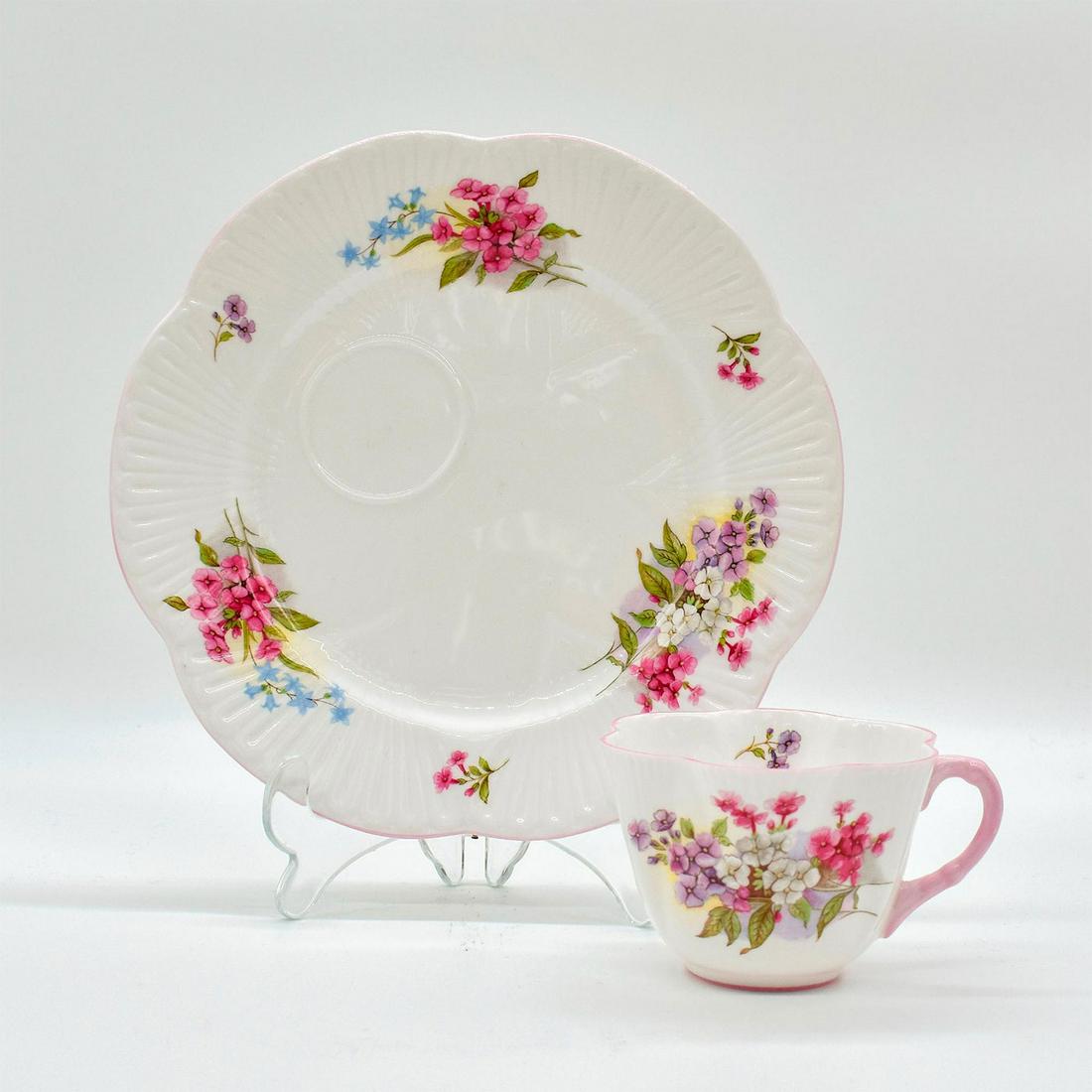 Shelley Snack Plate and Cup Set, Stocks: Fine Bone China. Dainty shape. Purple, pink, white, and blue floral pattern with pink scalloped rim. Shelley backstamp. Marked 13428. Cup: 2.5"H. Snack Plate: 8.2"W. #shelley #bonechina Issued: 1945-1