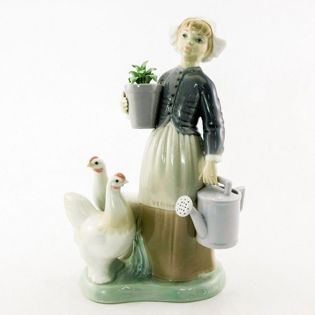 Girl with Hens 1001103 - Lladro Porcelain Figurine: Glossy finish; Lladro backstamp. Artist: Julio Fernandez Issued: 1971-1981 Dimensions: 9"H Manufacturer: Lladro Country of Origin: Spain