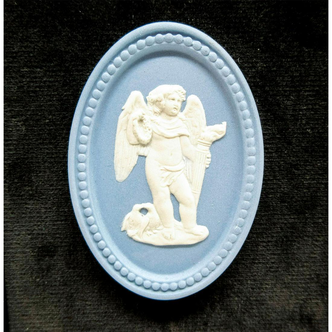 Wedgwood Pale Blue Jasperware, Cherub Plaque: Housed in brown wooden frame with black velvet mat board. Sprigged decoration of cherub with two birds. Loop hanger on the back. Wedgwood impressed on the back of medallion. Weight - 7.0 oz. Medallion