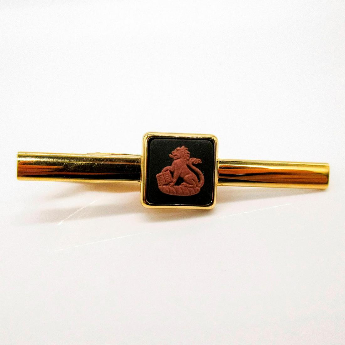 Wedgwood Jasperware Tie Clip, Lion with Book: Gold toned tie clip with terra cotta relief of a lion holding a book on black Jasperware. Wedgwood incised backstamp. PAT No.2164082. Jasper front face: .5"W. Includes box. #Wedgwood #Jasperware #Tiec