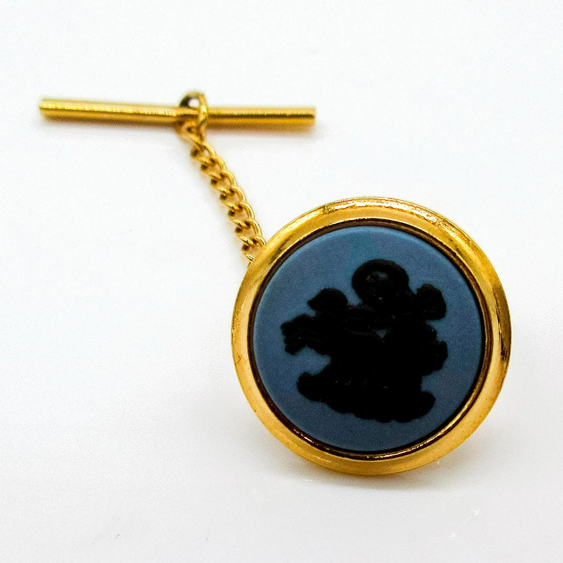 Wedgwood Jasperware Tie Tack with Chain, Aurora: Gold toned tie tack with chain, black basalt Aurora relief on blue Jasperware. Wedgwood incised backstamp. Includes box. #Wedgwood #Tietack Issued: 20th c. Dimensions: 1.75"L x .5" dia. Manufacturer: