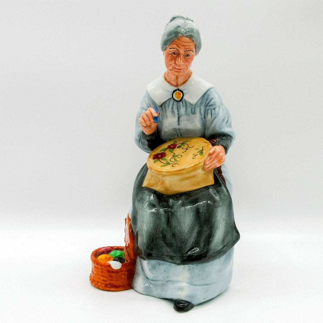 Embroidering HN2855 - Royal Doulton Figurine: Golden Years Series. Grey and blue coloration; glazed. Doulton backstamp. Artist: William K. Harper Issued: 1980 - 1990 Dimensions: 7.25"H Manufacturer: Royal Doulton Country of Origin: England