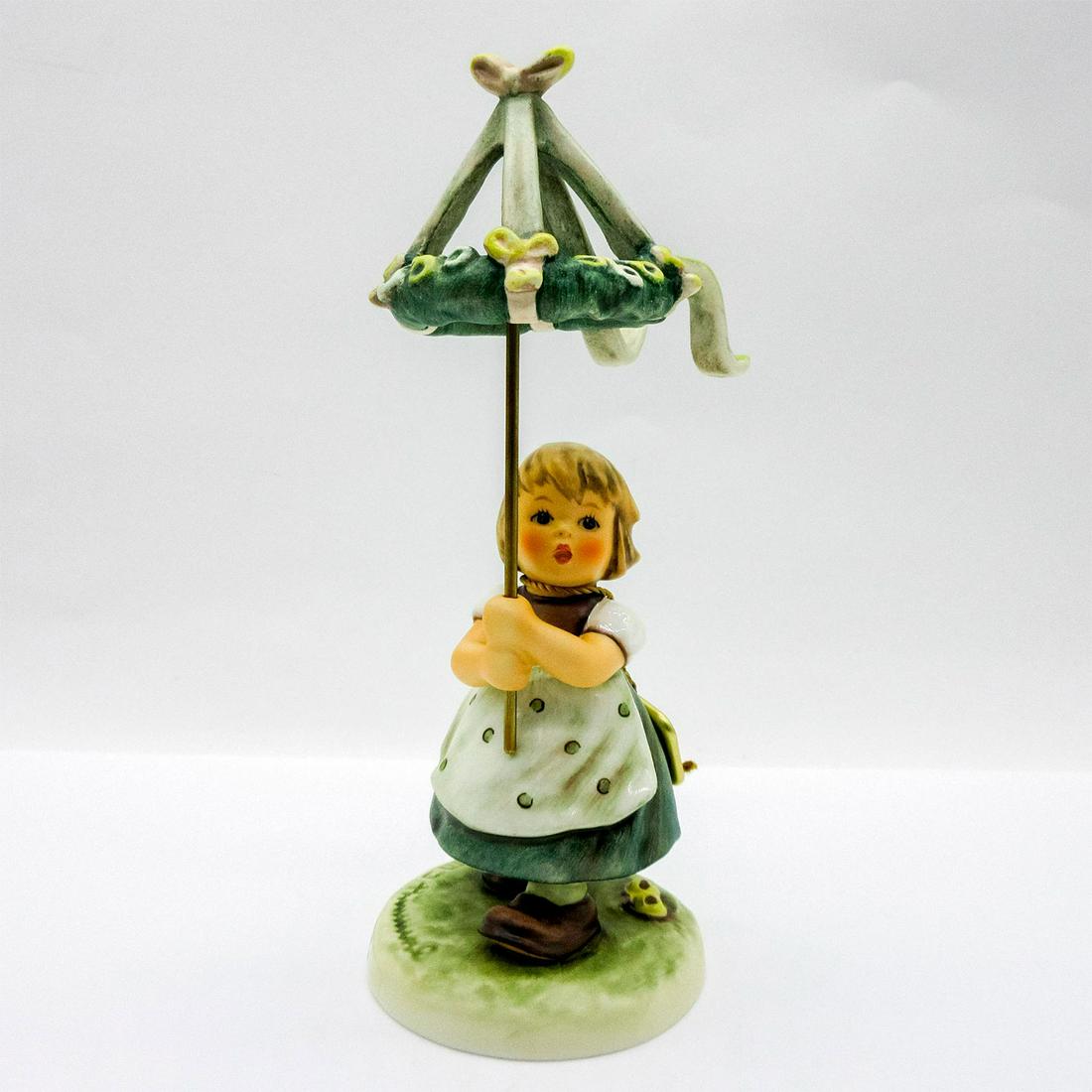 Goebel Hummel Figurine, May Dance: Porcelain hand painted figure of a young girl holding a May Pole joining in the traditional May 1 celebration. M J Hummel stamped to base; Goebel backstamp. Includes Certificate of Authenticity. In or
