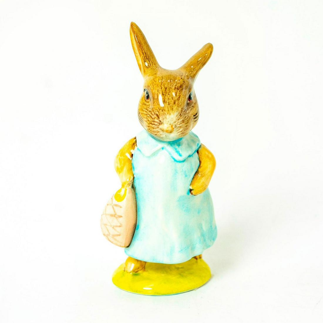 Mrs. Flopsy Bunny - Royal Albert - Beatrix Potter Figurine: Royal Albert Backstamp. Dark/ Light blue dress, pink bag. Artist: Arthur Gredington Issued: 1965 - 1998 Dimensions: 4''H Manufacturer: Beswick Country of Origin: England
