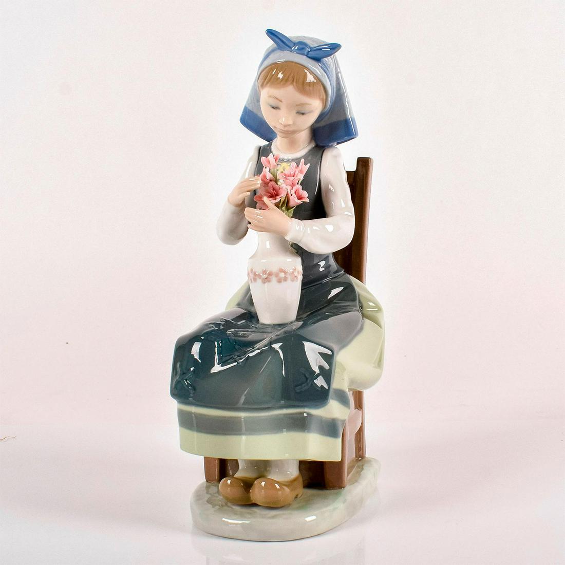 Flower Harmony 1001418 - Lladro Porcelain Figurine: Glossy porcelain. Lladro backstamp. Includes original box. Artist: Francisco Catalï¿½ Issued: 1982 - 1995 Dimensions: 8.25"H x 3.25"W Manufacturer: Lladro Country of Origin: Spain