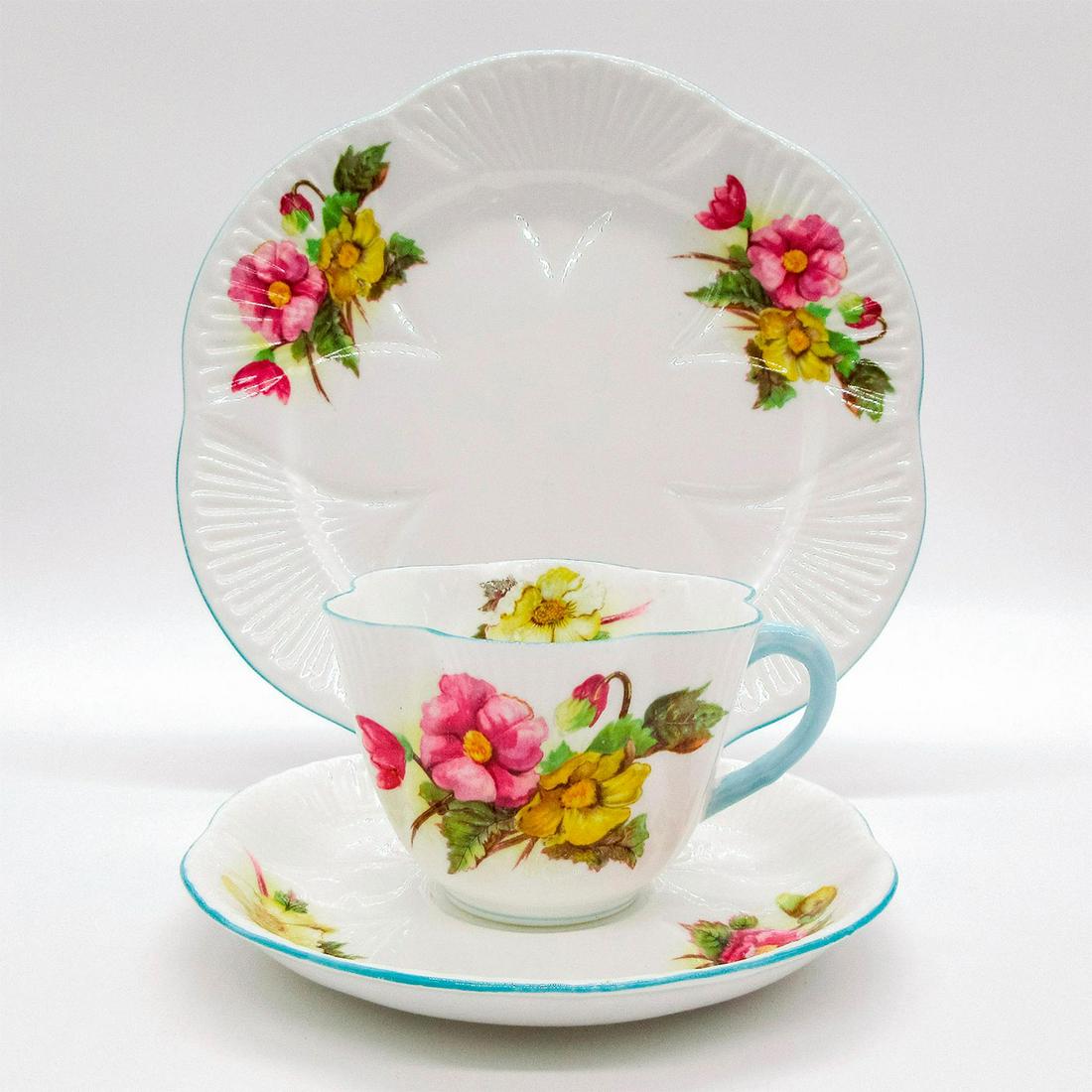 3pc Shelley England Tea Set Trio, Begonia: Vintage bone china tea wares; Dainty shape. Yellow and pink begonia flower pattern with pastel blue rim. Shelley England backstamp. Scalloped rim. 13427 stamped on base. Cup size - 2.5"H x 3.5" diamet