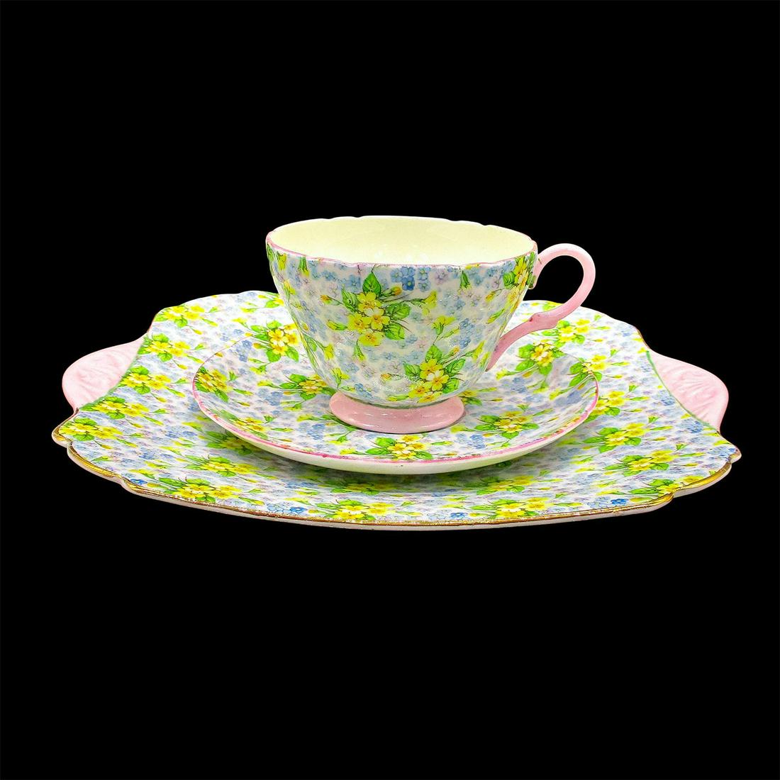 3pc Shelley England Tea Set Trio, Primrose Chintz: Cup and saucer have pink rim. Plate has gilt rim. Fine Bone China Shelley England backstamp on all. Cup 2.5"H. Saucer 5.75"W. Plate 9.5"W. Issued: 1945-1966 Dimensions: 9.5"W x 2.5"H Manufacturer: She