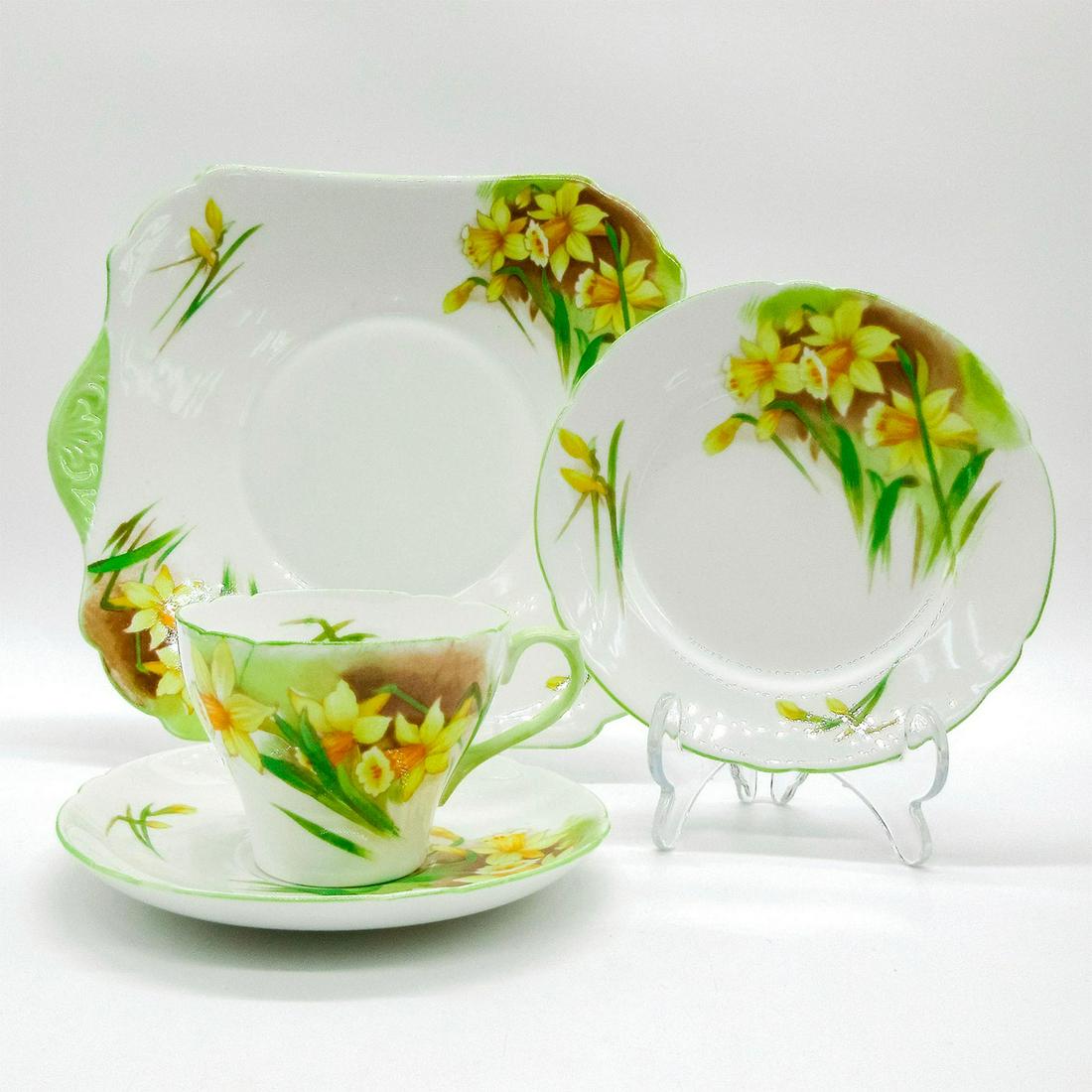 4pc Shelley England Tea Set, Jonquil Daffodils: Vintage bone china tea set; Cambridge shape. Yellow daffodil flower pattern with pistachio green rim. Shelley England backstamp. 13670 stamped on base. Cup size - 2.5"H x 3.5" diameter (widest). Sauce