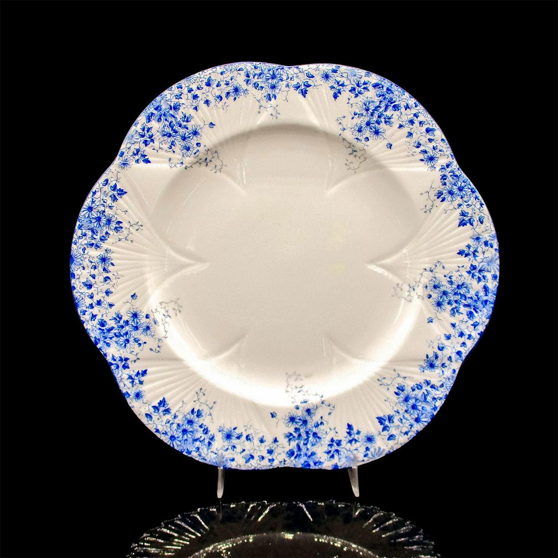 Shelley England Dinner Plate, Dainty Blue Pattern: Delicate blue flowers decorate the lip. Blue rim, Dainty shape. Fine Bone China Shelley England backstamp. 10.75"W. Issued: 1945-1966 Dimensions: 10.75"W Manufacturer: Shelley Pottery Country of Origi