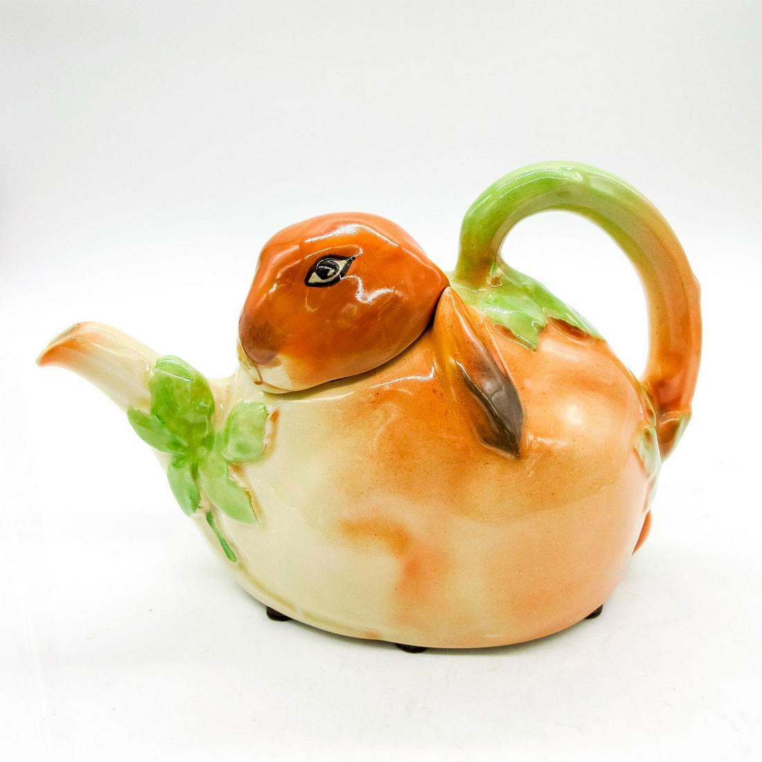 Royal Doulton Seriesware, Bunnykins Breakfast Teapot D6010: Tea pot from original Bunnykins Breakfast set by Charles Noke, issued c.1939 Rabbit shaped with lid. In brown, tan, cream, and green coloration. Royal Doulton backstamp. With felt circles around base.