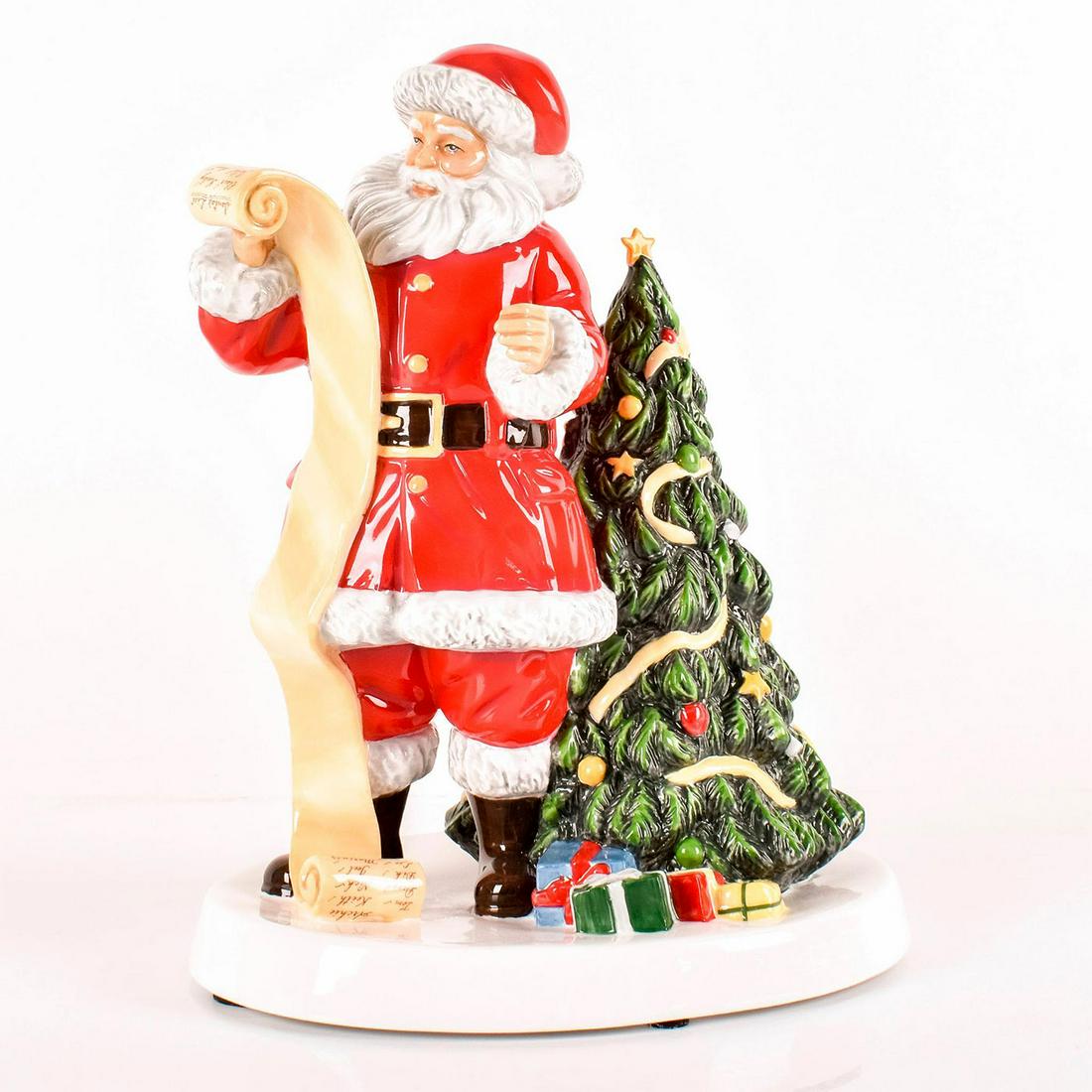Father Christmas 2018 HN5891 - Royal Doulton Figurine: Bone China. Jolly Santa reads from a scroll bearing the names of the children he's leaving gifts for under the brilliantly decorated Christmas tree. Series: Father Christmas. Royal Doulton backstamp. 
