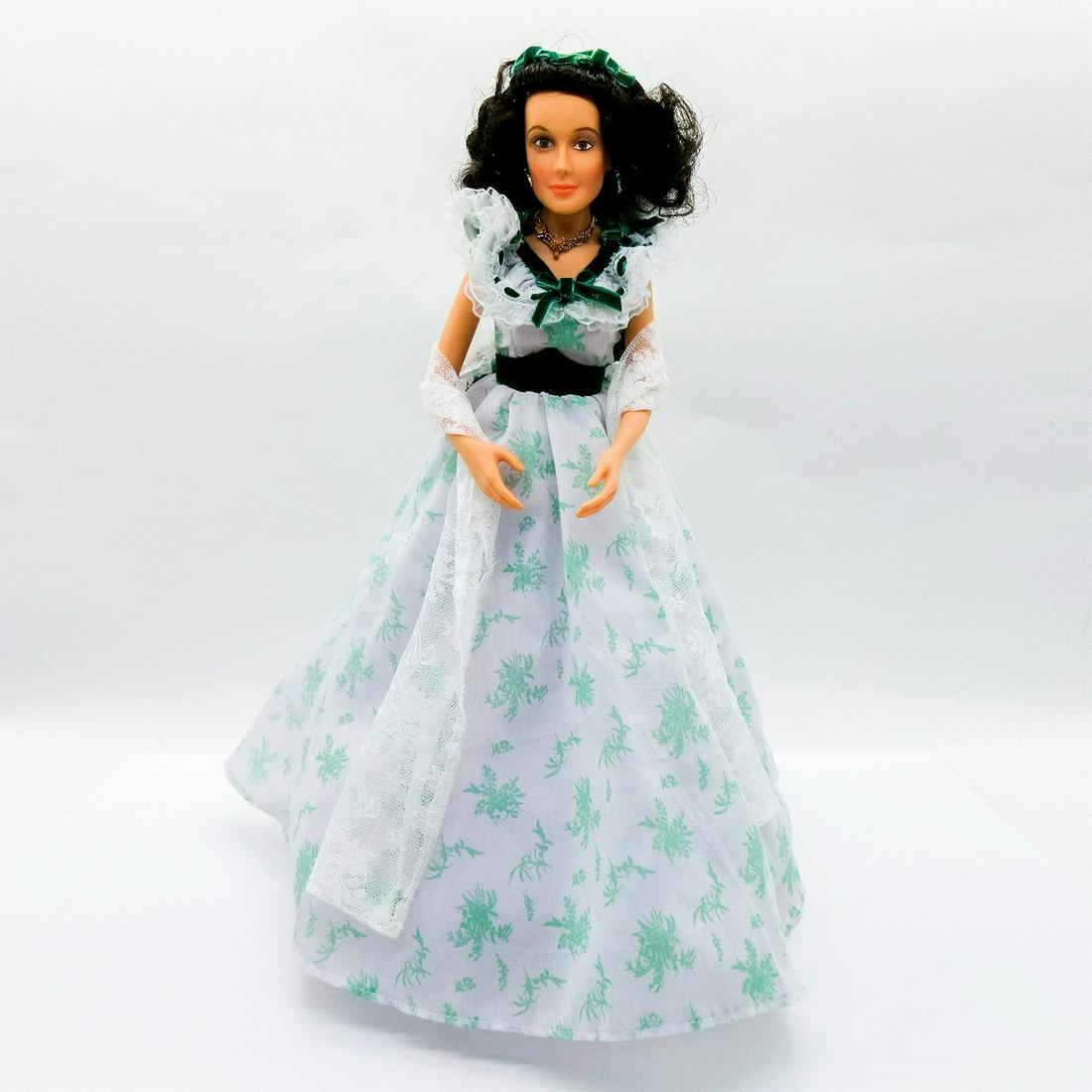 Ashton-Drake Galleries Doll, Scarlett Belle of the Barbeque: Scarlett in white dress with green floral pattern, velvet ribbon accents at lace ruffle above bodice. She wears gold tone jewelry with coral accents. Includes straw hat, lace shawl, stand and Certific