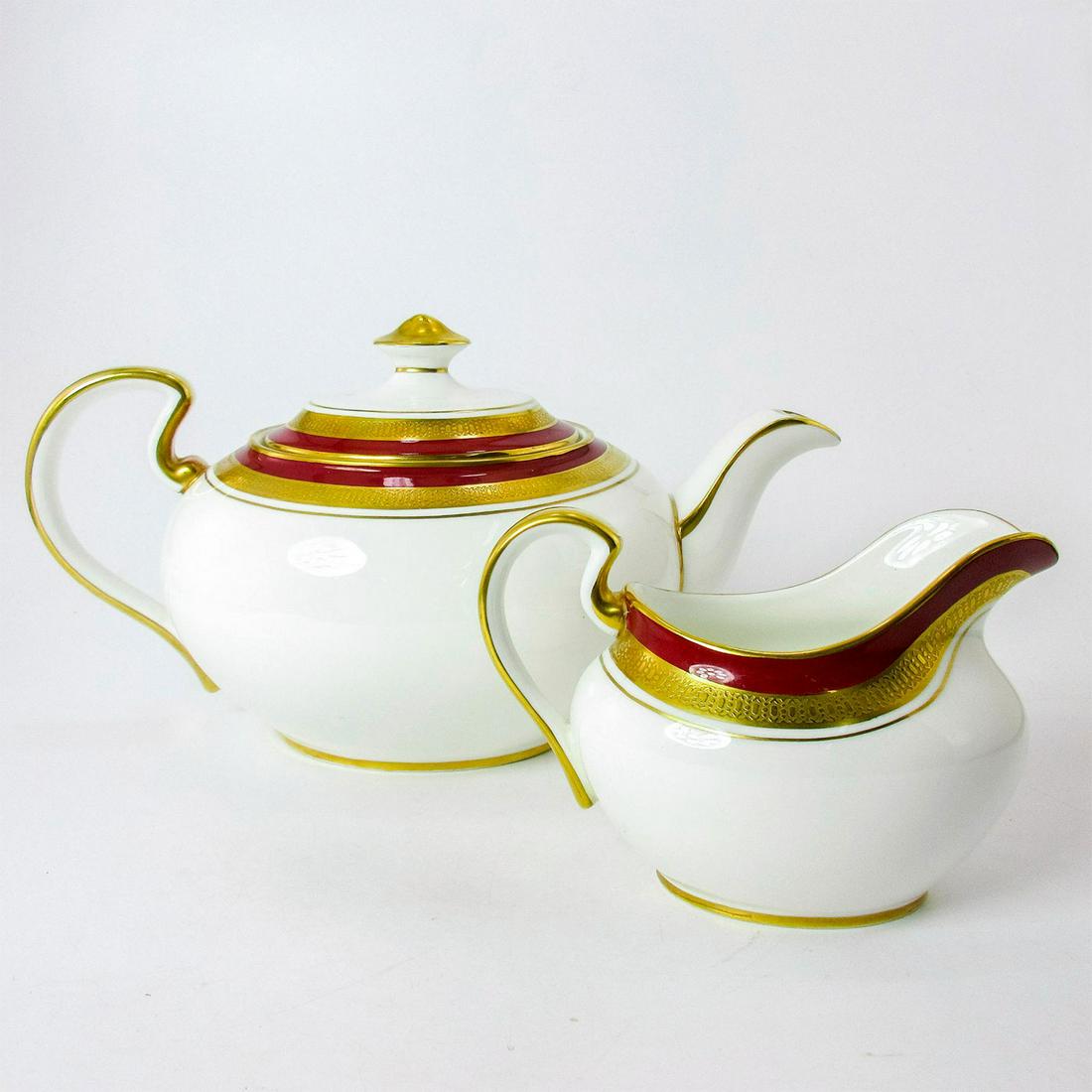 2pc Set John Aynsley Tea Pot and Creamer Marone Royale: Bone China. Red and Gold rim. Tea Pot is 11"L x 5"W x 5"H. Creamer is 5.5"L x 3"W x 3.75"H. Aynsley backstamp. #Dinnerware #England #Ceramics Manufacturer: Aynsley Country of Origin: England