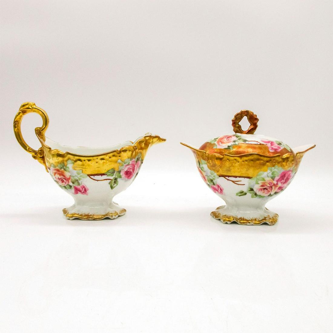 2pc Set Limoges France Blakeman & Henderson Creamer & Sugar: Floral pattern with gold accents. Limoges backstamp. Creamer is 6.5"L x 4.5"H x 3"W. Sugar bowl is 4.5"H x 5.5"L x 3.5"W.#Porcelain #Antiques Artist: Blakeman & Henderson Issued: 20th c. Manufacturer: